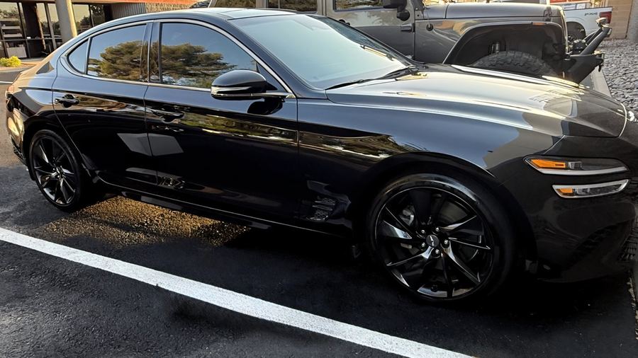 Black Genesis sedan with mirror-clean exterior finish